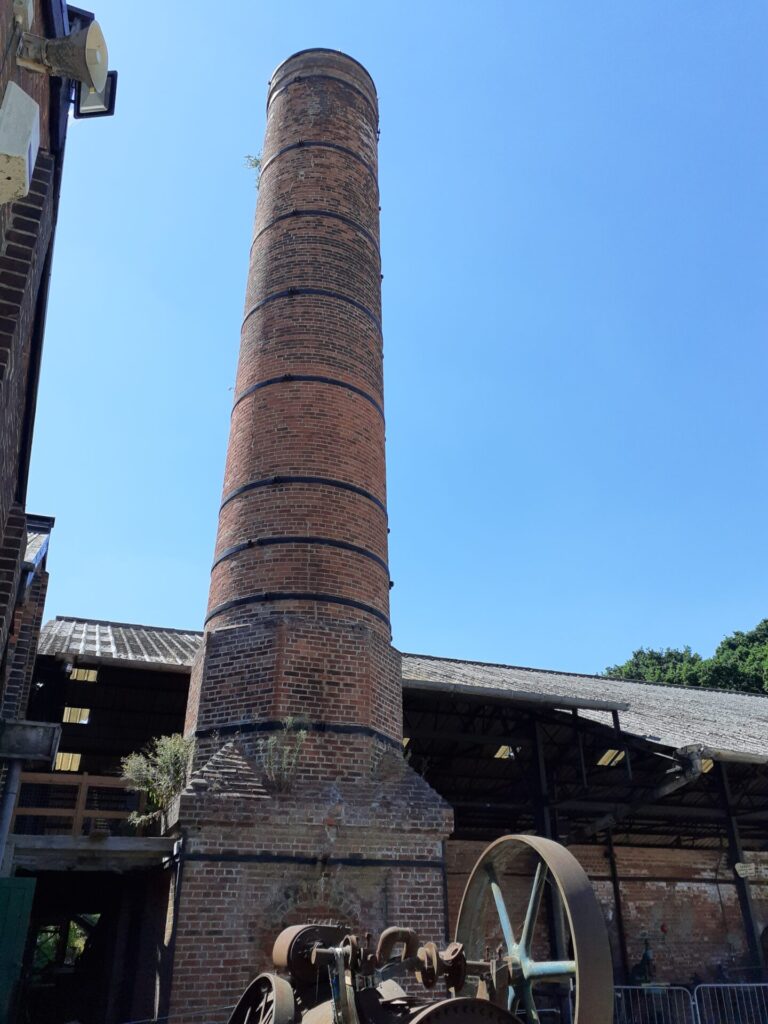 A tall brick chimney at a brickworks museum