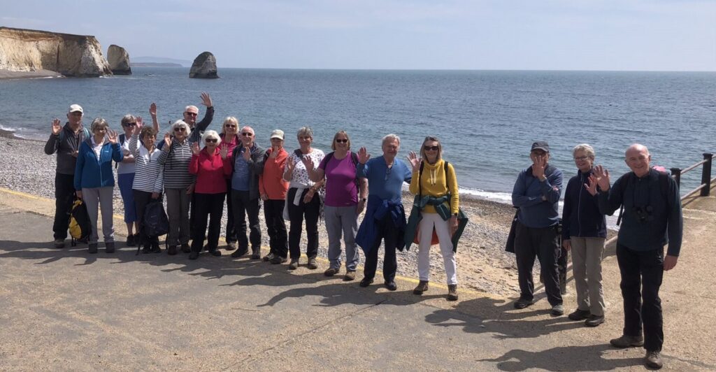 A group of walkers on the beach on the isle of wight
