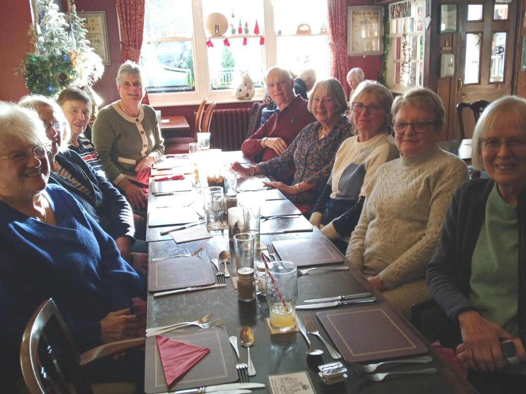 A group of 8 women and one man sat around a large table in the Ship Inn fordingbridge