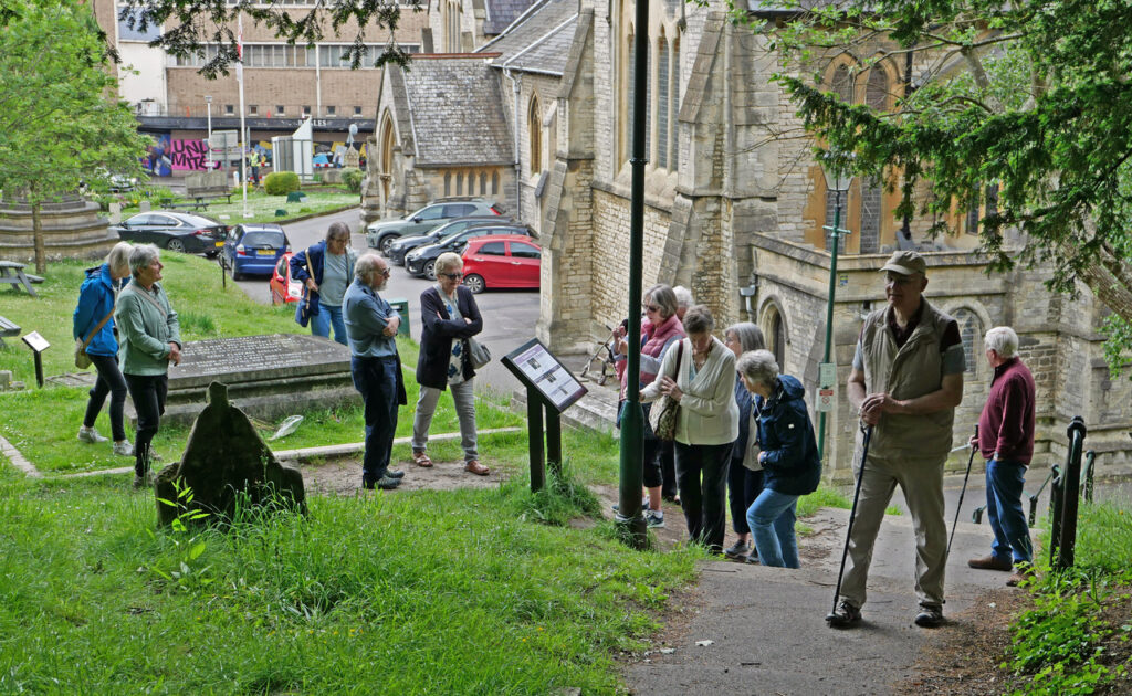 A group o f12 people in a churchyard